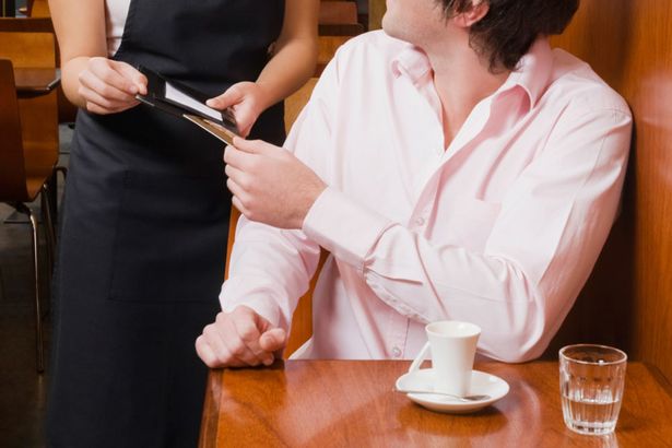 Customer-paying-his-bill-to-a-waitress