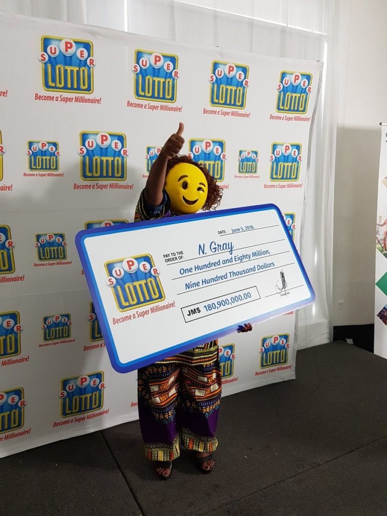 Jamaican lottery winner shows up in a mask to claim her 180 Million prize